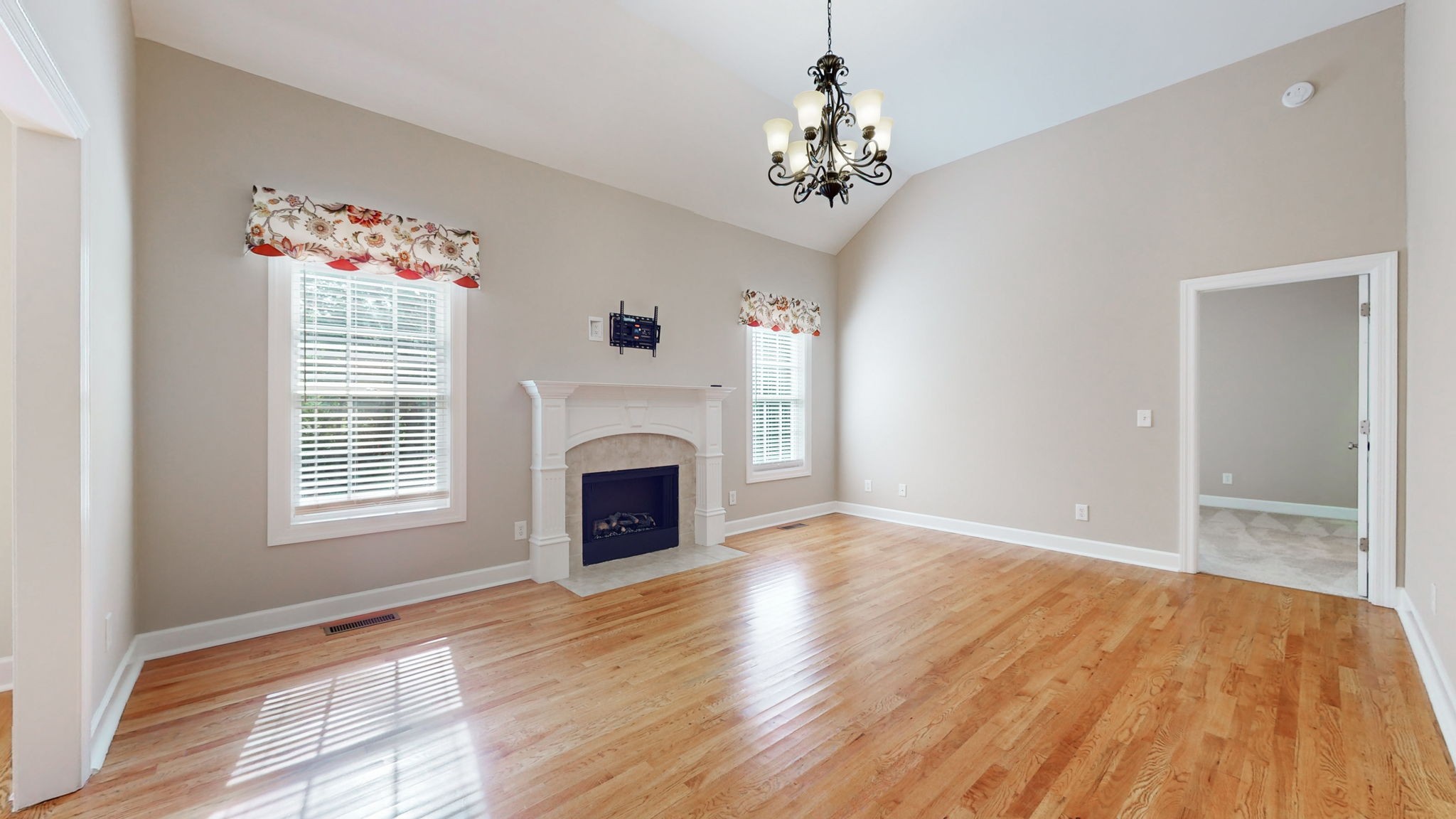 257 Conquest Road Murfreesboro, TN 37128 - Photo 6 of 44 a view of an empty room with a window and wooden floor
