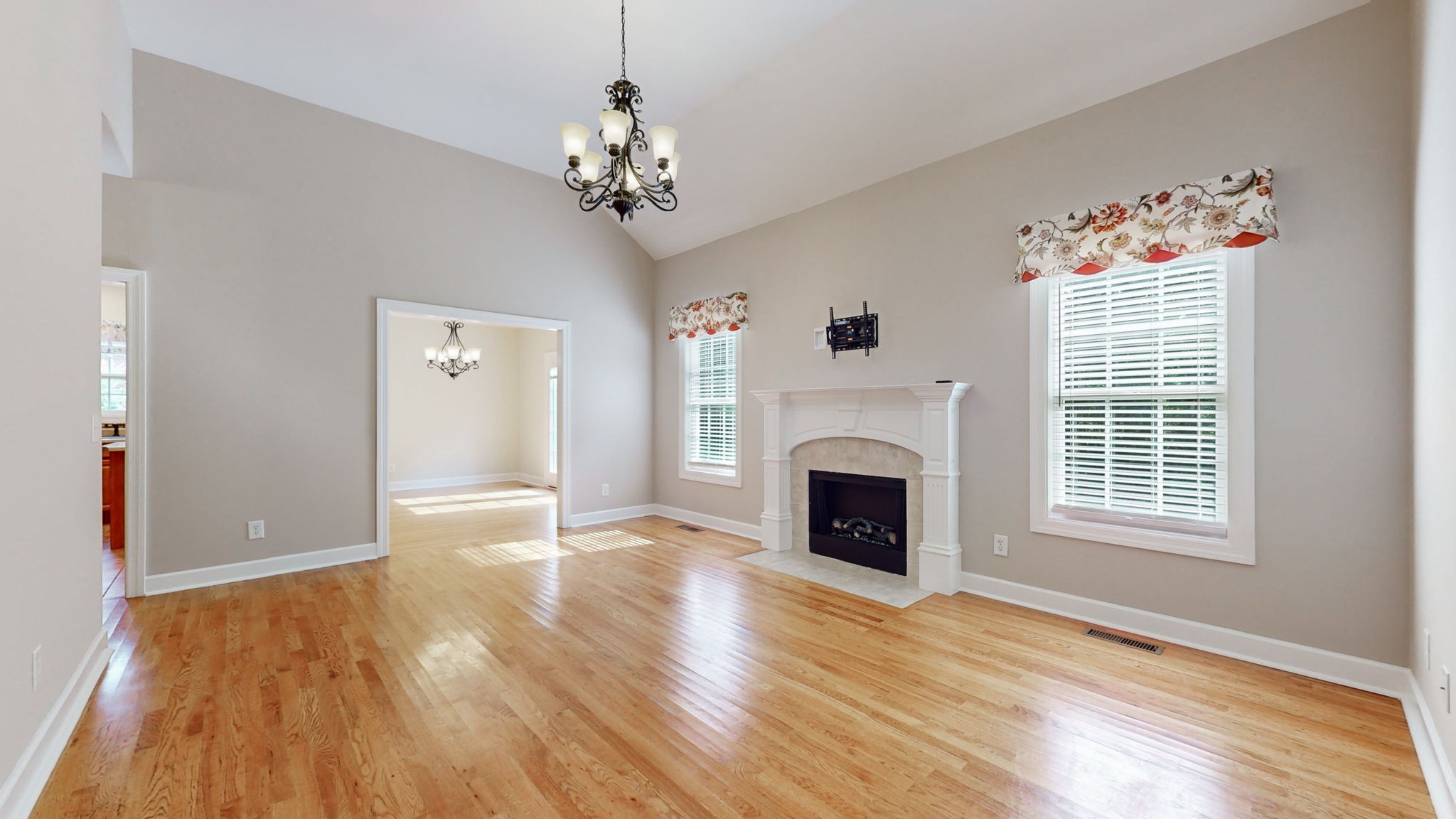 257 Conquest Road Murfreesboro, TN 37128 - Photo 7 of 44 a view of an empty room with a fireplace and wooden floor