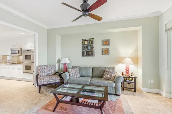 a living room with furniture and a potted plant