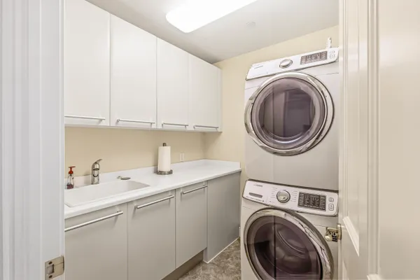 a utility room with sink dryer and washer