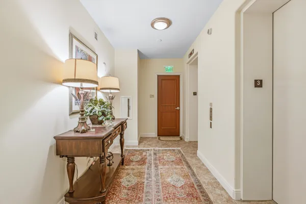 a view of a hallway to a livingroom and furniture