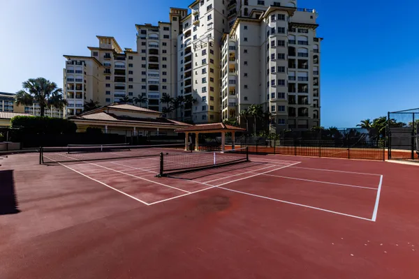 a view of a tennis court with buildings