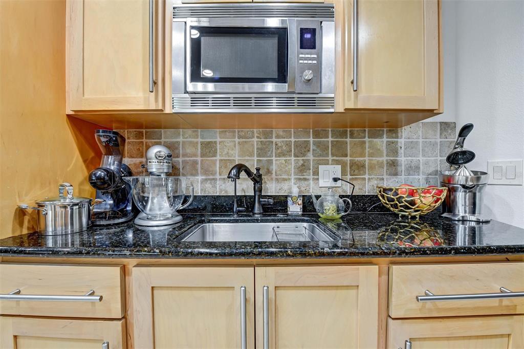 1875 Belleair Road Clearwater, FL 33764 - Photo 17 of 100 a kitchen with granite countertop a sink and cabinets
