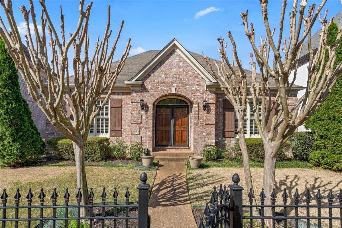1495 Kimbrough Road Germantown, TN 38138 - Photo 1 of 31 View of front of house with brick siding, a fenced front yard, and a shingled roof