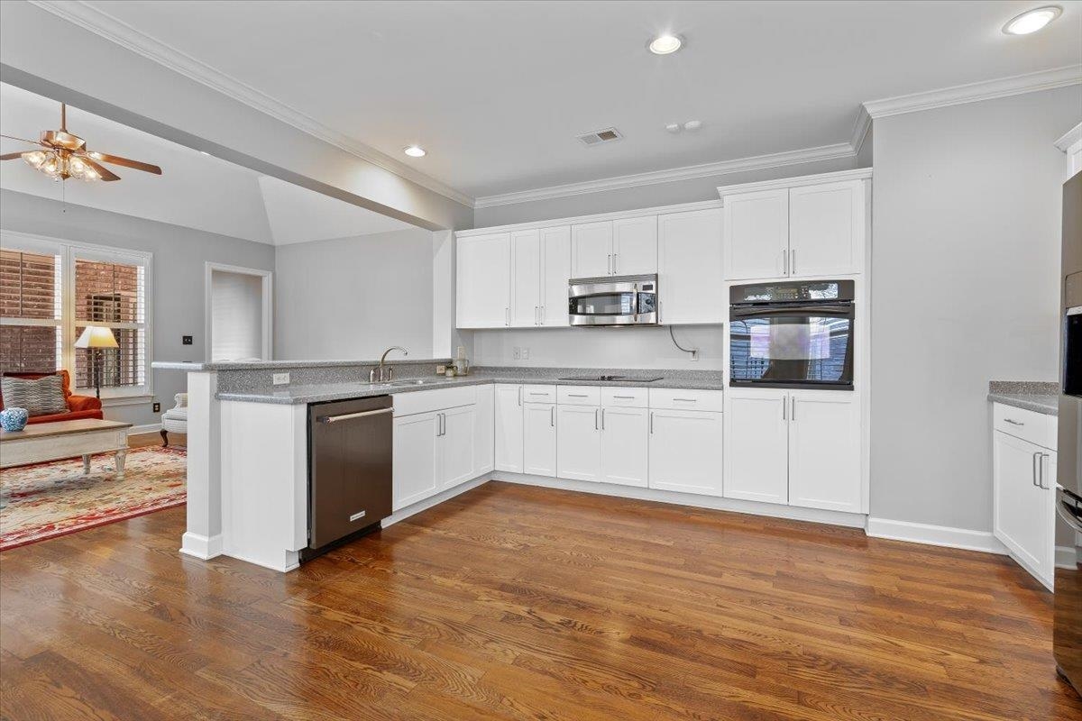 1495 Kimbrough Road Germantown, TN 38138 - Photo 14 of 31 Kitchen featuring white cabinetry, dark wood-style flooring, a sink, ceiling fan, and black appliances