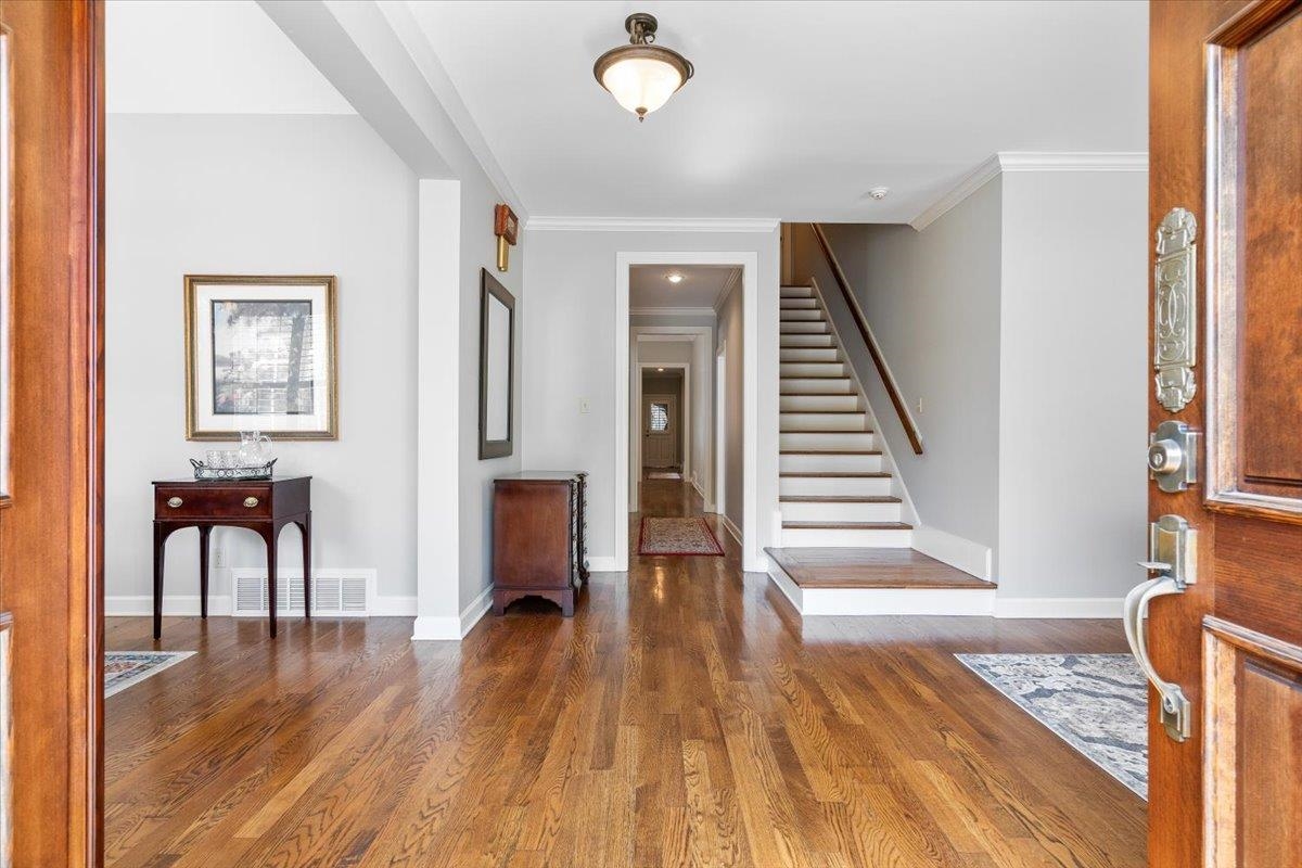 1495 Kimbrough Road Germantown, TN 38138 - Photo 2 of 31 Entrance foyer featuring crown molding, stairway, wood finished floors, baseboards, and visible vents
