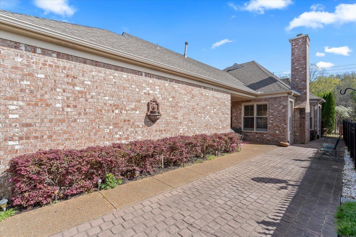 1495 Kimbrough Road Germantown, TN 38138 - Photo 27 of 31 Exterior space with a chimney, fence, and brick siding