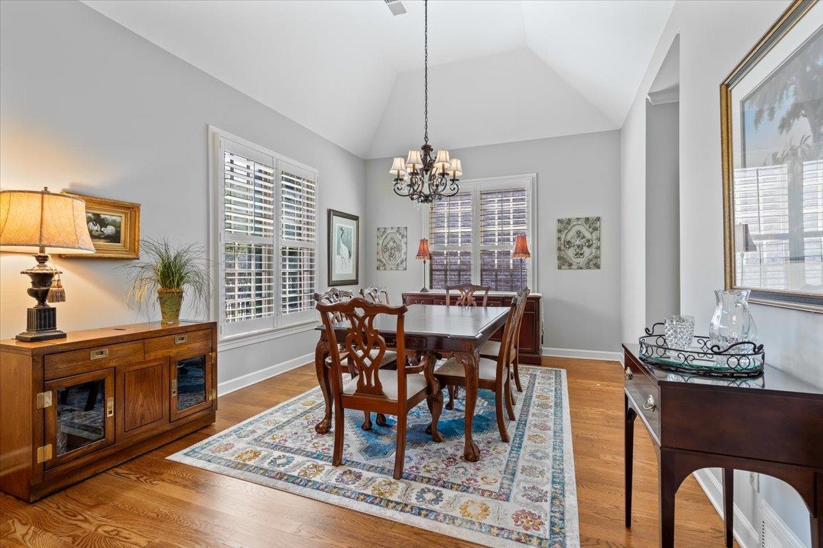 1495 Kimbrough Road Germantown, TN 38138 - Photo 8 of 31 Dining room with an inviting chandelier, baseboards, lofted ceiling, and wood finished floors