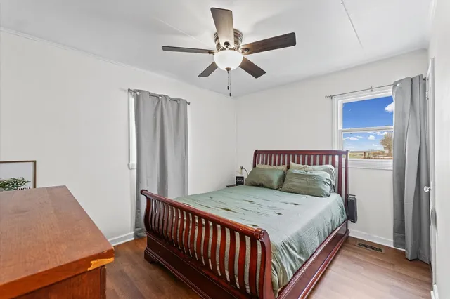 a bed sitting in a bedroom next to a window