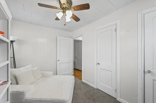 a bedroom with a bed and a ceiling fan