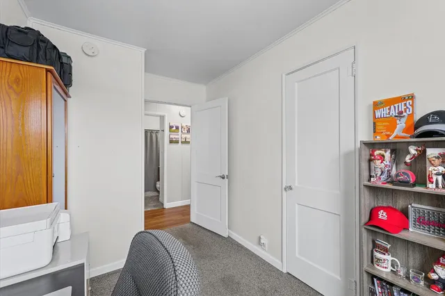 a bedroom with a bed and a book shelf