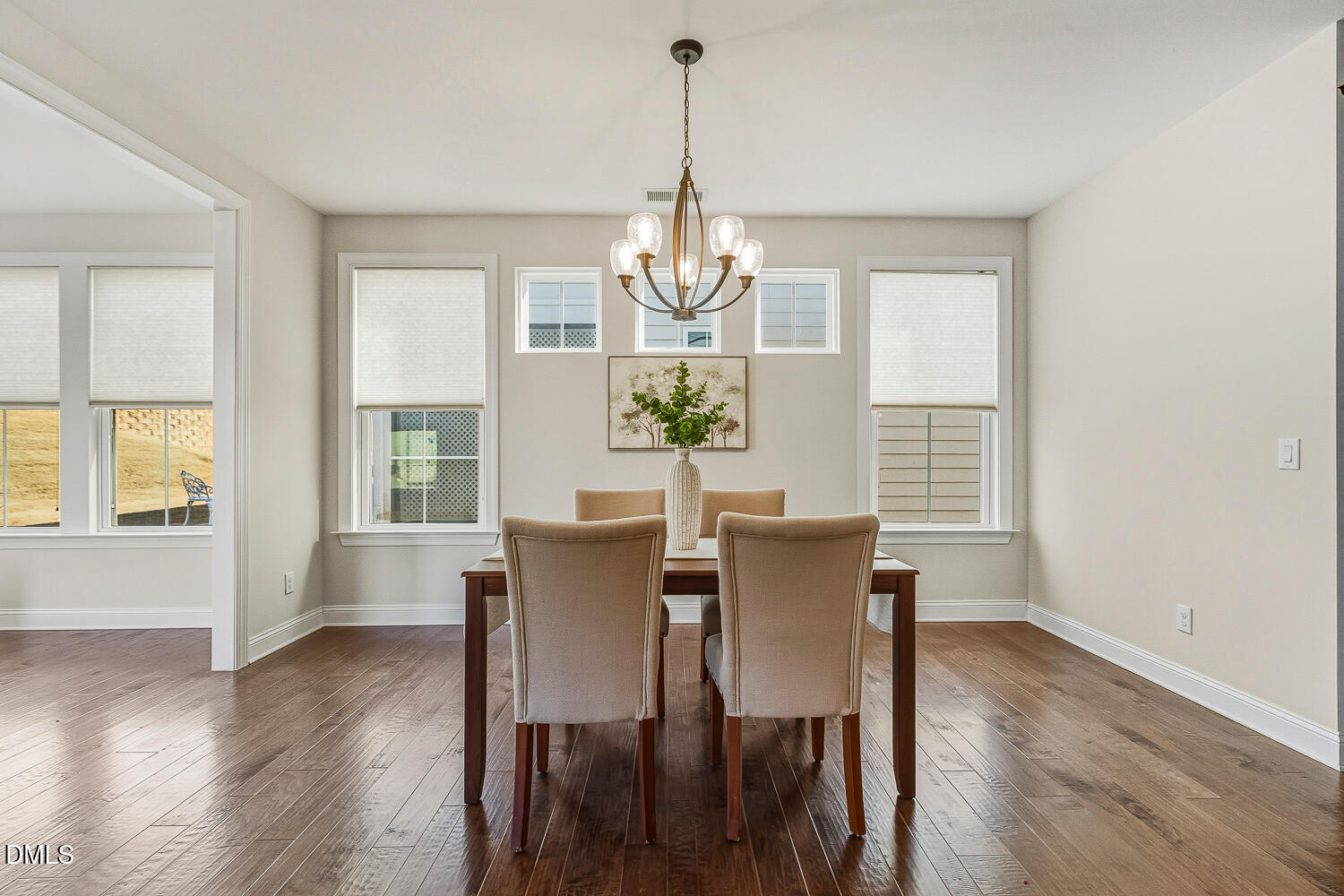 1025 Nickelby Street Durham, NC 27703 - Photo 25 of 71 a dining room with wooden floor a chandelier a wooden table and chairs
