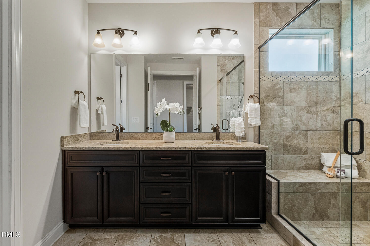 1025 Nickelby Street Durham, NC 27703 - Photo 37 of 71 a bathroom with a granite countertop sink a mirror and a shower