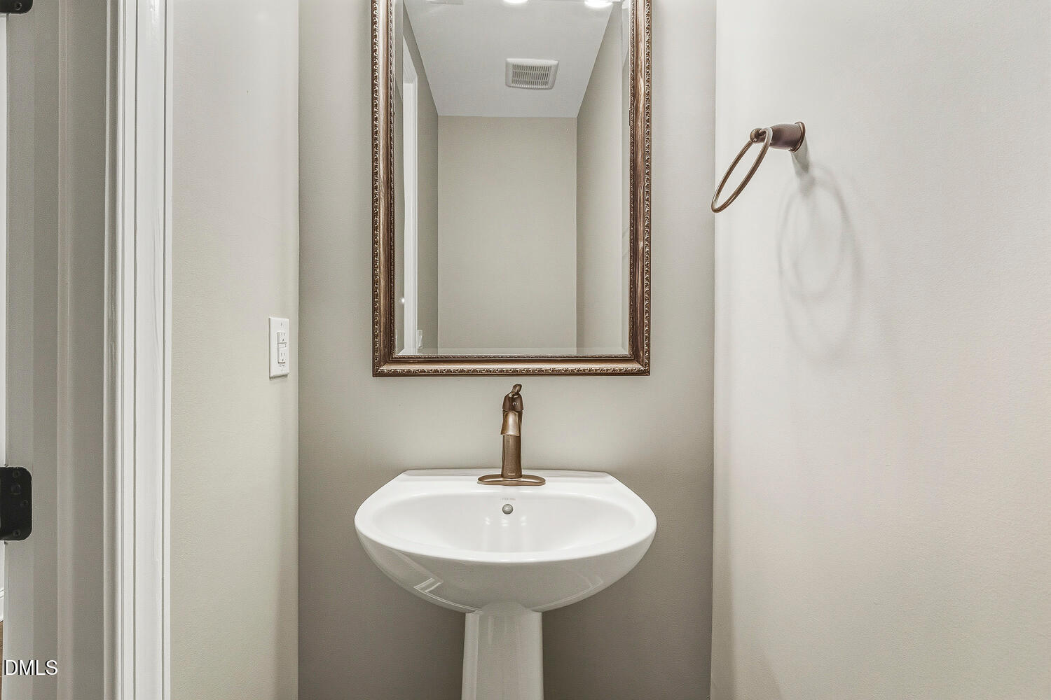 1025 Nickelby Street Durham, NC 27703 - Photo 43 of 71 a bathroom with a sink and mirror