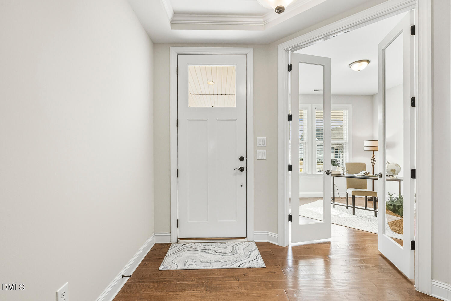 1025 Nickelby Street Durham, NC 27703 - Photo 44 of 71 a view of a hallway with wooden floor and a bathroom
