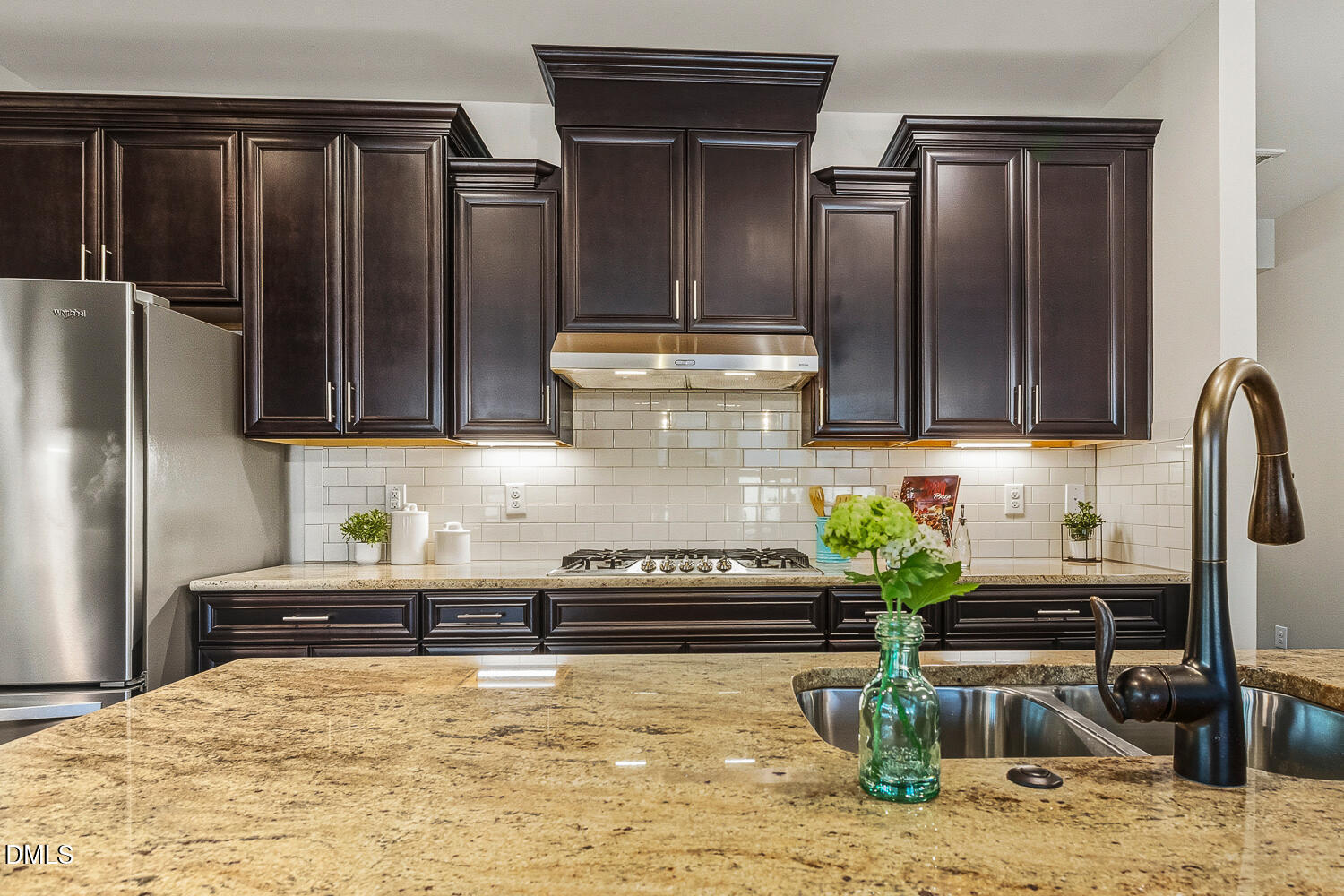 1025 Nickelby Street Durham, NC 27703 - Photo 7 of 71 a kitchen with granite countertop a refrigerator and a stove top oven