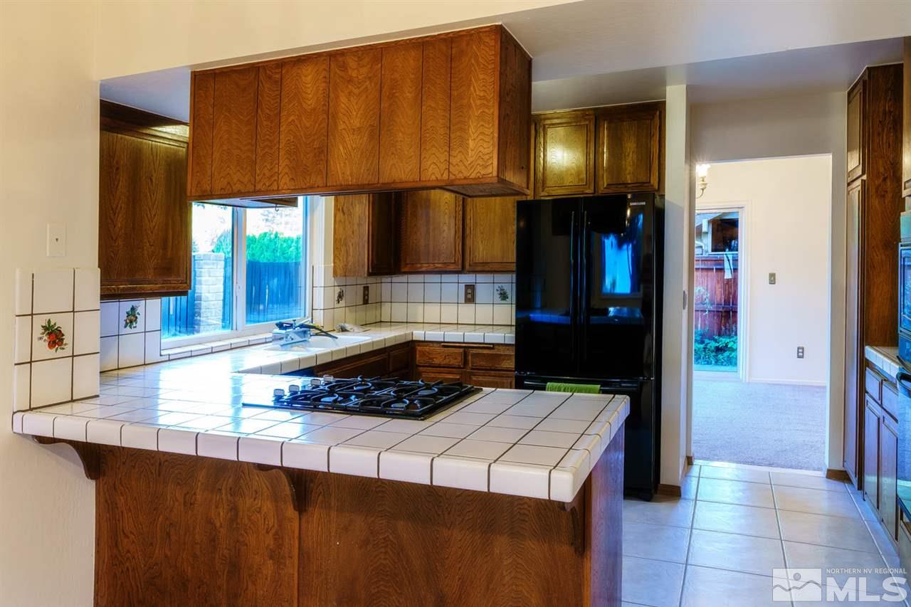465 Anne Marie Court Reno, NV 89509 - Photo 8 of 21 a kitchen with a sink a stove and a refrigerator