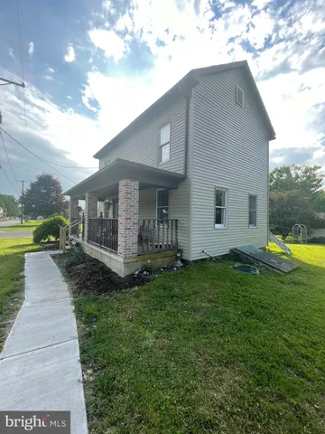 a view of a house with a yard porch and sitting area