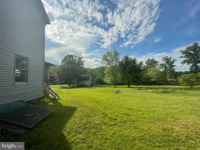 a view of a big yard with an outdoor space