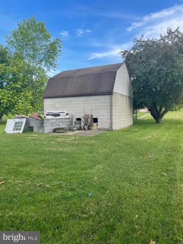 a front view of a house with a garden and plants