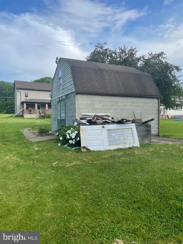 a backyard of a house with yard and trampoline