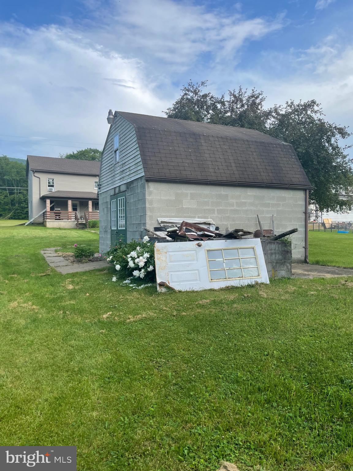 5035 Back Maitland Road McClure, PA 17841 - Photo 24 of 28 a front view of a house with a garden and plants