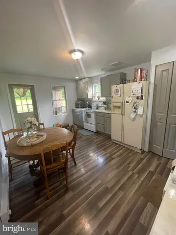 a kitchen with a table and chairs in it