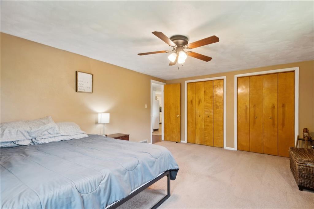1213 Lower Mateer Road Vandergrift, PA 15690 - Photo 12 of 28 a bedroom with a large bed and a chandelier