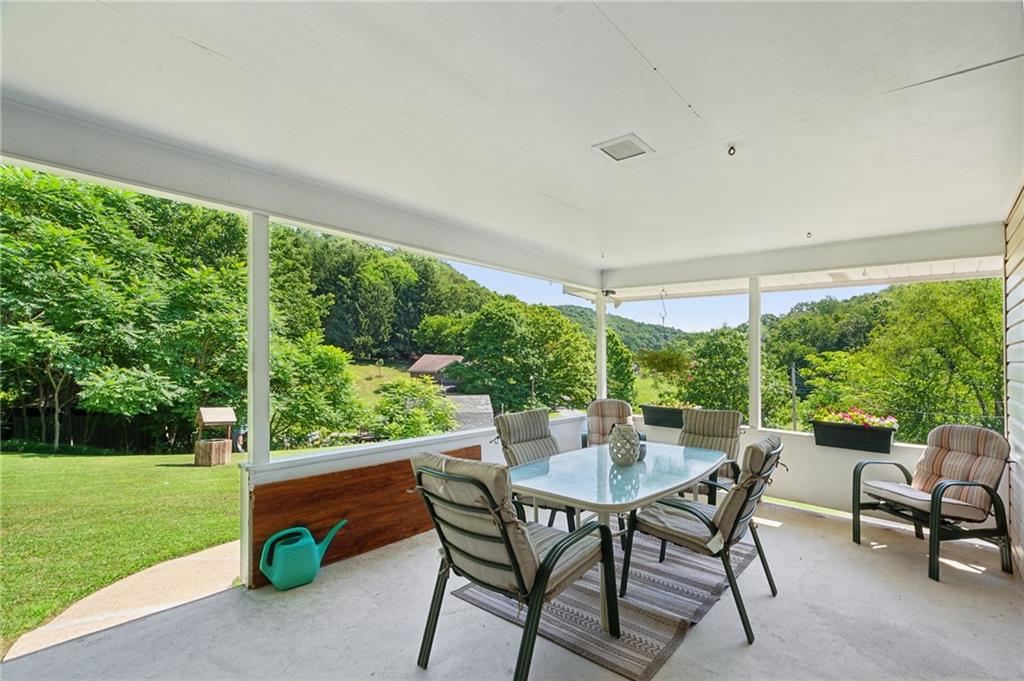 1213 Lower Mateer Road Vandergrift, PA 15690 - Photo 4 of 28 a view of a patio with a table chairs and a yard