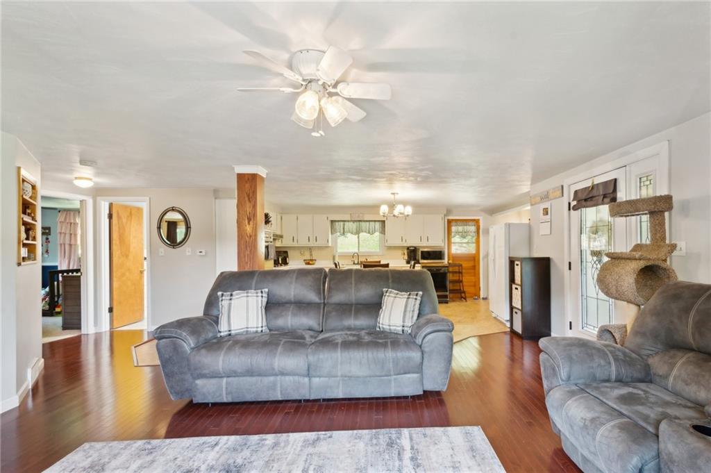 1213 Lower Mateer Road Vandergrift, PA 15690 - Photo 7 of 28 a living room with fireplace furniture and a wooden floor