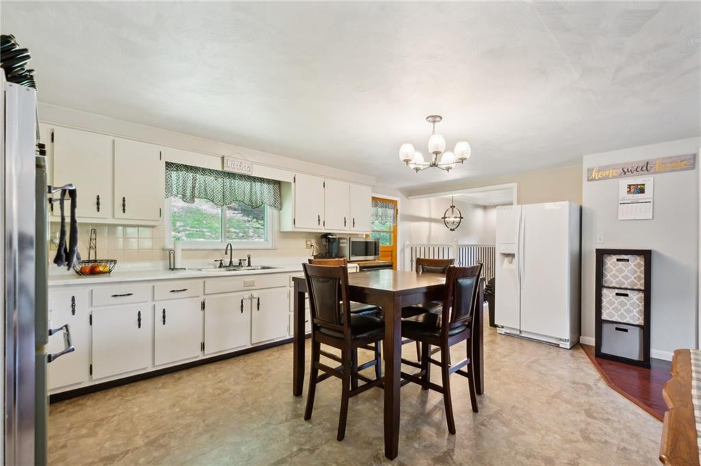 1213 Lower Mateer Road Vandergrift, PA 15690 - Photo 9 of 28 a large kitchen with cabinets and wooden floor