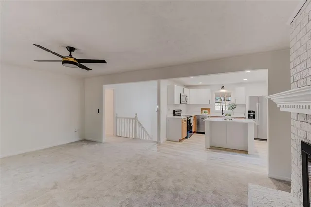 a view of a livingroom with furniture and a ceiling fan