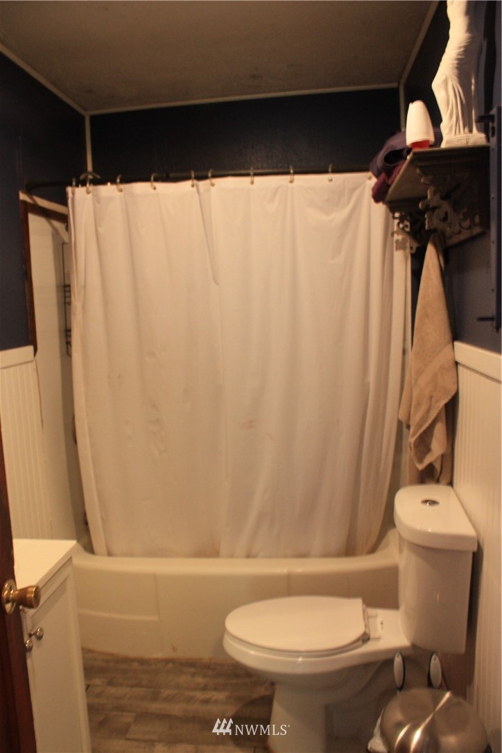 171 Poetsch Road Toledo, WA 98591 - Photo 13 of 23 a white toilet sitting next to a shower curtain