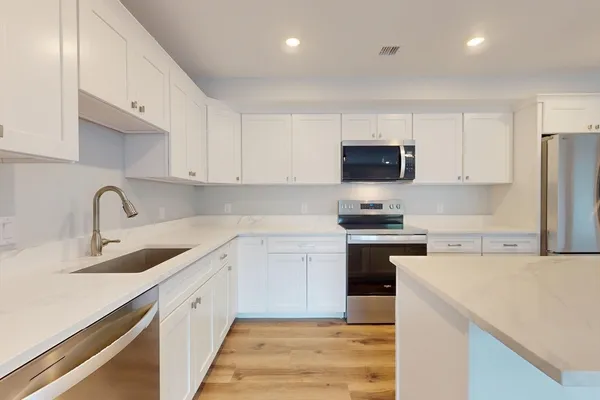 a kitchen with a sink stove and refrigerator