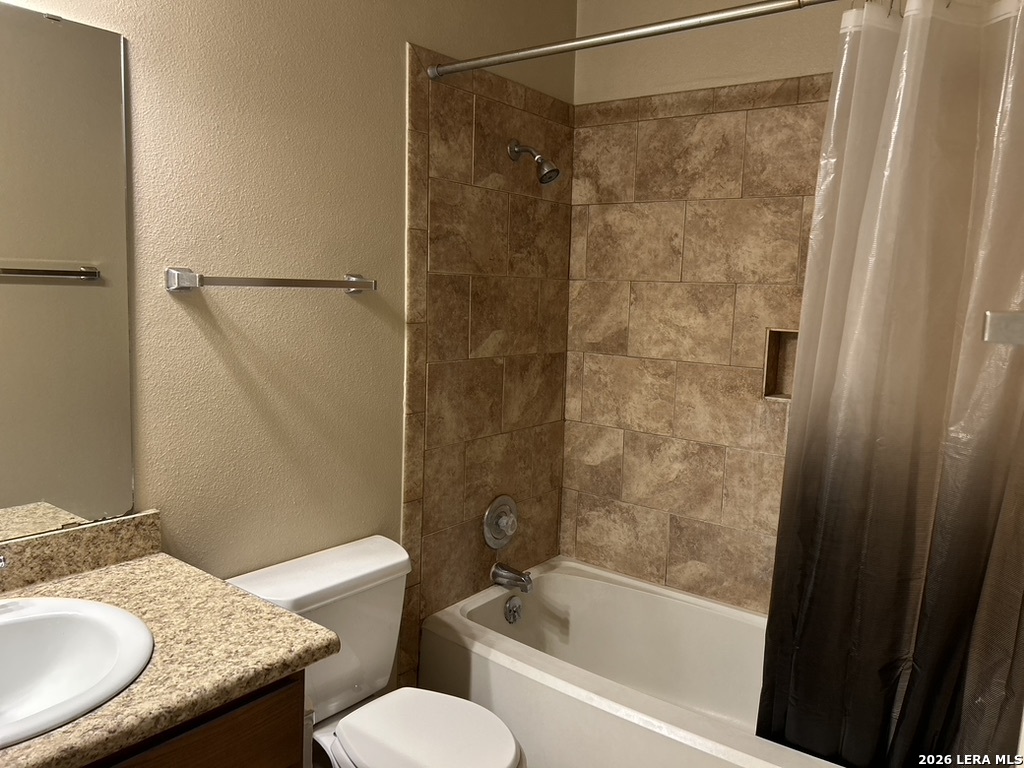 13018 Heimer Road, Unit 710 San Antonio, TX 78216 - Photo 17 of 27 a bathroom with a granite countertop bathtub shower sink vanity and toilet