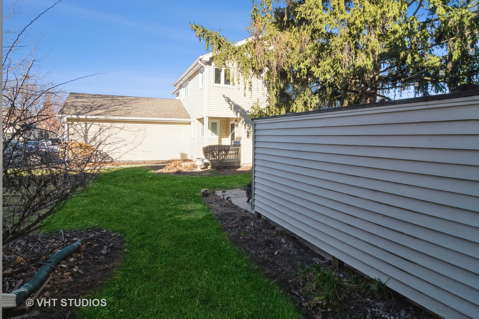 4S768 Pinehurst Drive Naperville, IL 60563 - Photo 17 of 21 a view of a backyard with plants and a large tree