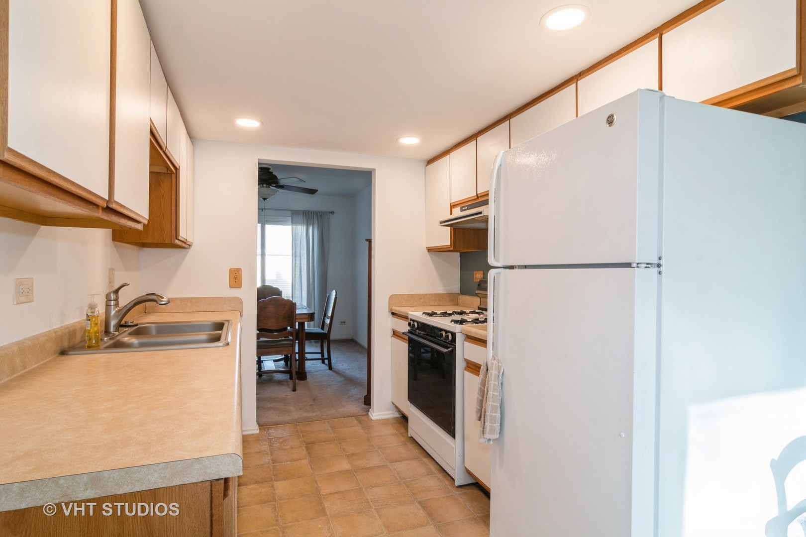 4S768 Pinehurst Drive Naperville, IL 60563 - Photo 6 of 21 a kitchen with a refrigerator a stove top oven a sink and dishwasher