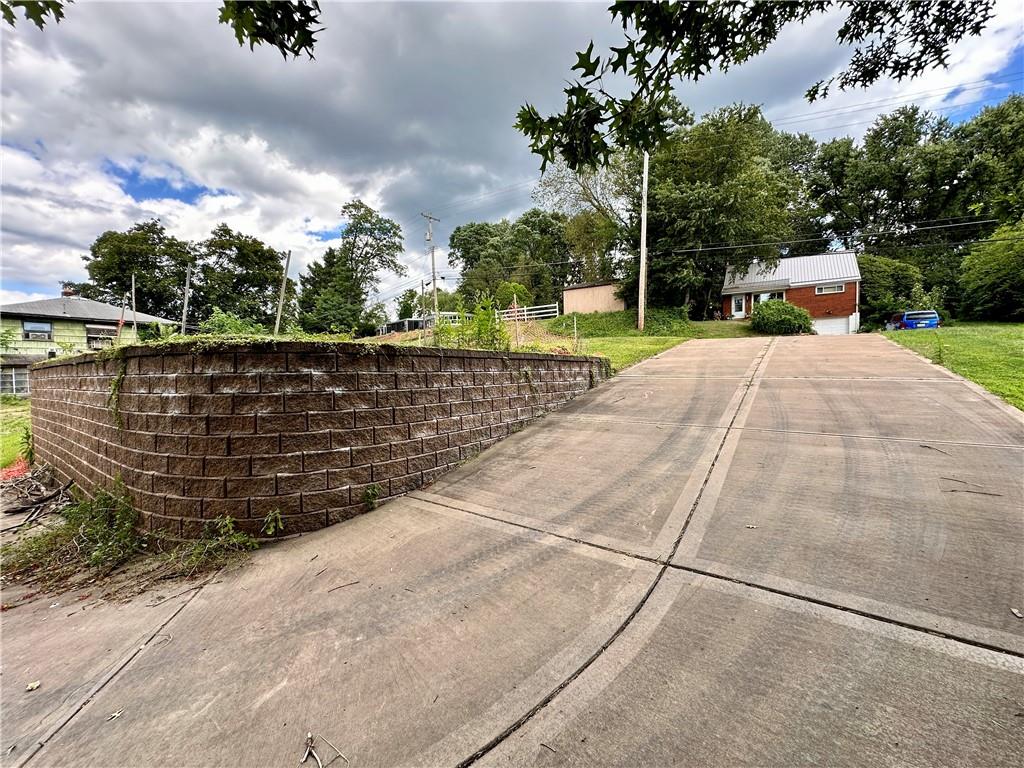 435 Millers Lane Pittsburgh, PA 15239 - Photo 4 of 7 a view of a lake with a bench and trees around