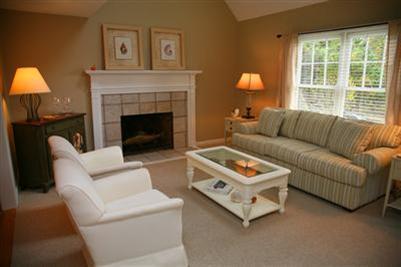 32 Meadowbrook Road Mashpee, MA 02649 - Photo 2 of 16 a living room with furniture a fireplace and a large window