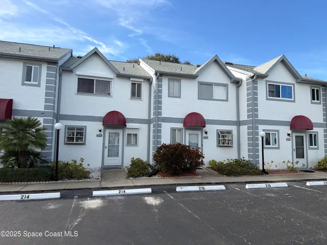 a front view of multiple houses with yard