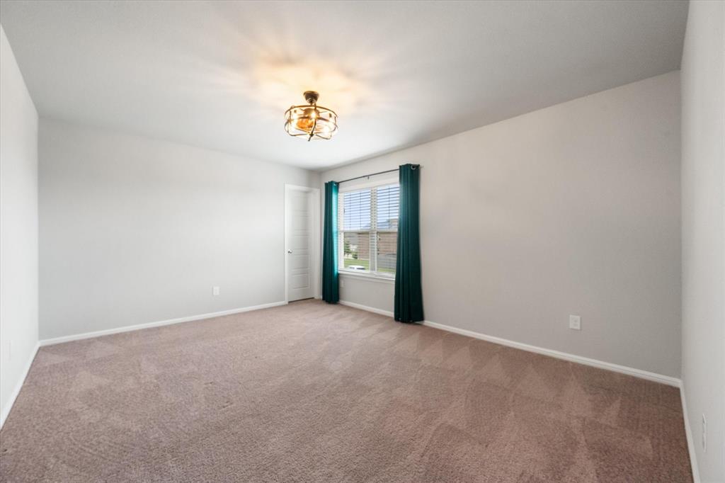6910 Prairieside Trail Venus, TX 76084 - Photo 33 of 40 This room features light grey walls and brown carpeting, creating a neutral canvas
