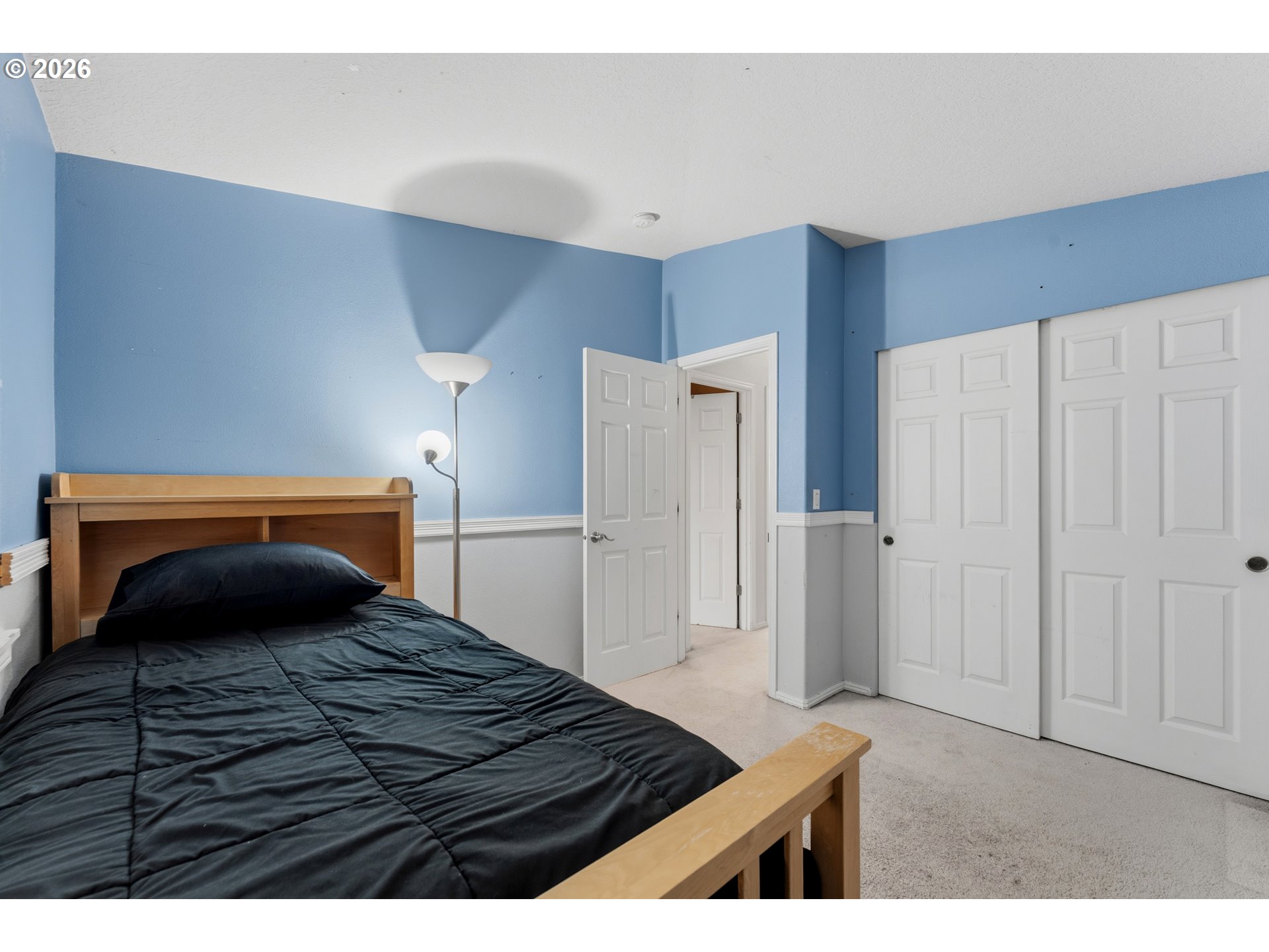 15852 Southeast Upman Way Damascus, OR 97089 - Photo 17 of 43 a bedroom with a bed and a refrigerator