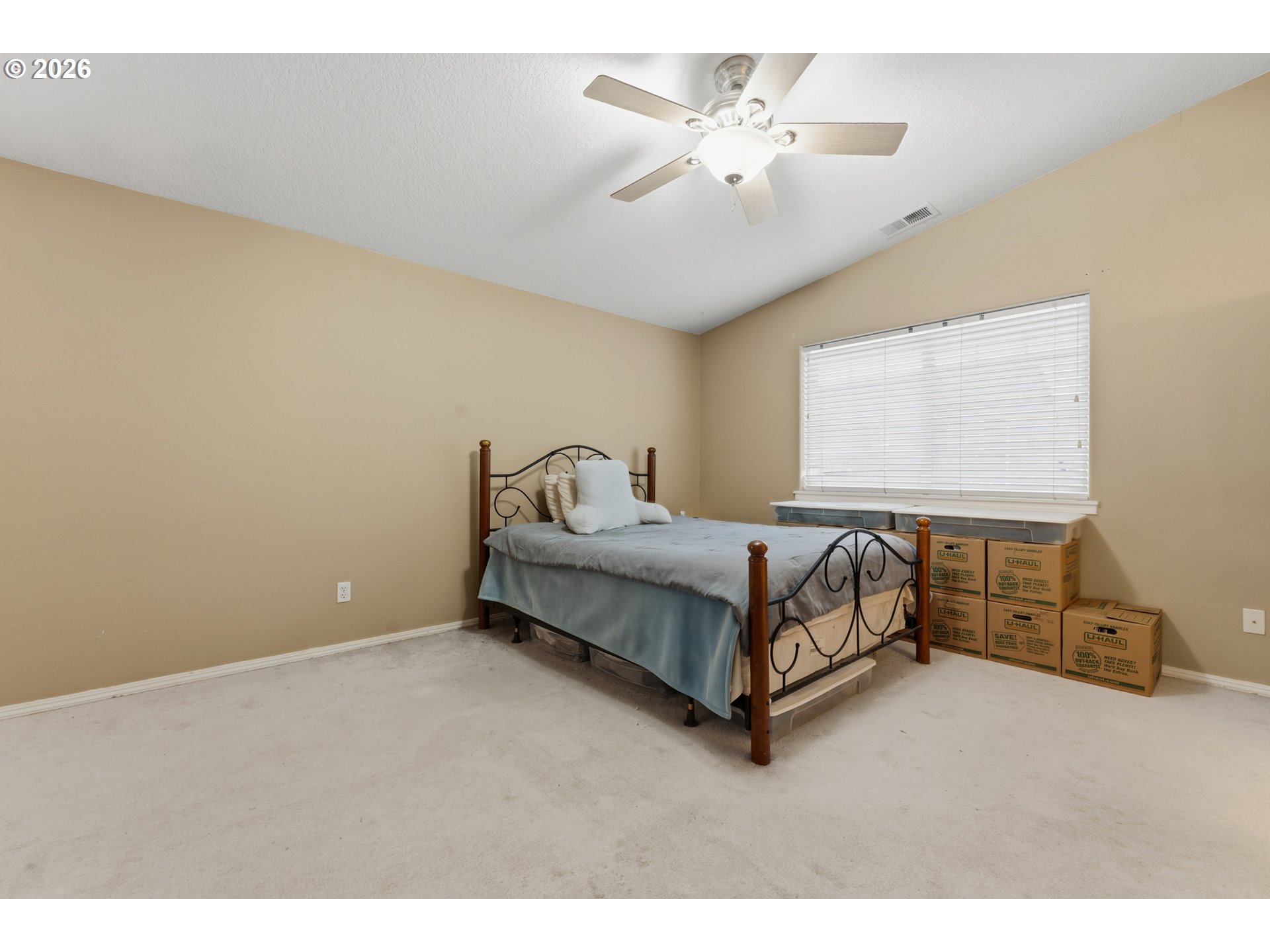 15852 Southeast Upman Way Damascus, OR 97089 - Photo 21 of 43 a bedroom with a bed and a chandelier