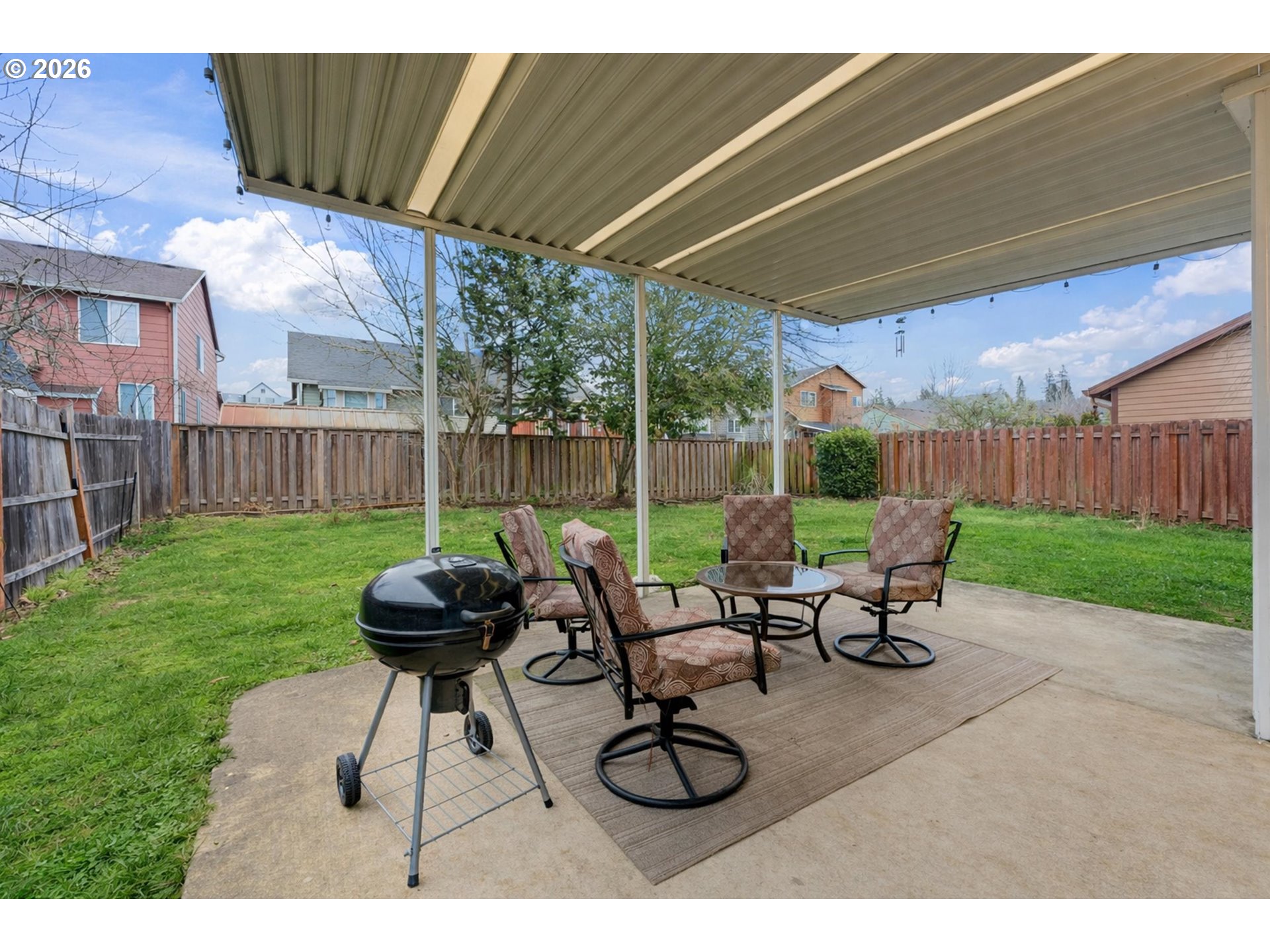 15852 Southeast Upman Way Damascus, OR 97089 - Photo 31 of 43 a view of a patio with table and chairs with a barbeque grill