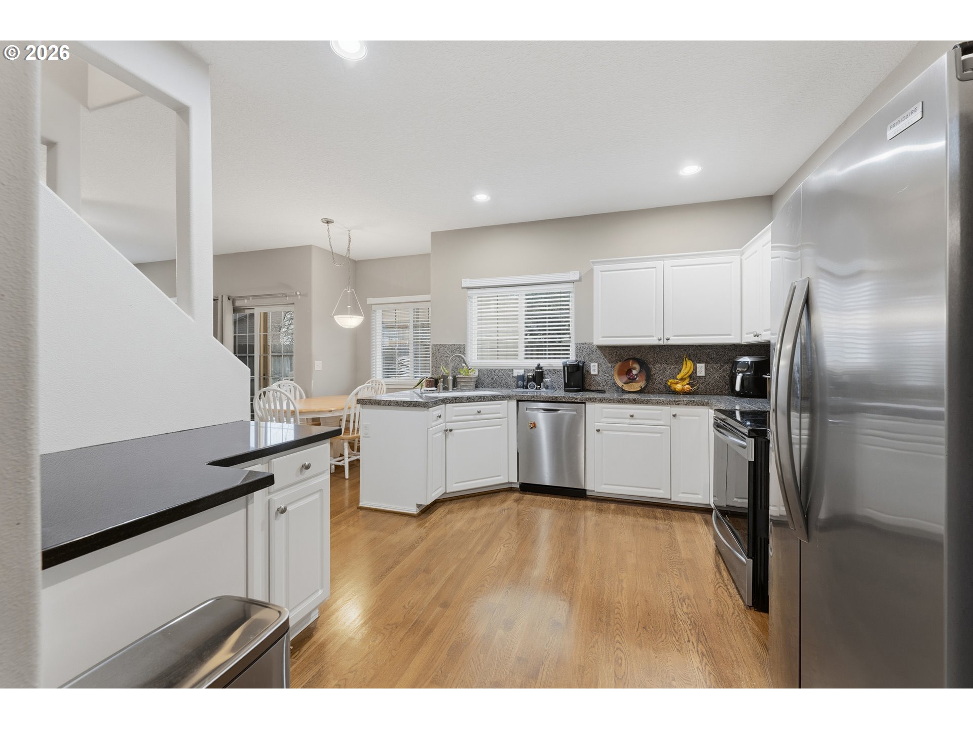 15852 Southeast Upman Way Damascus, OR 97089 - Photo 7 of 43 a kitchen with cabinets and stainless steel appliances