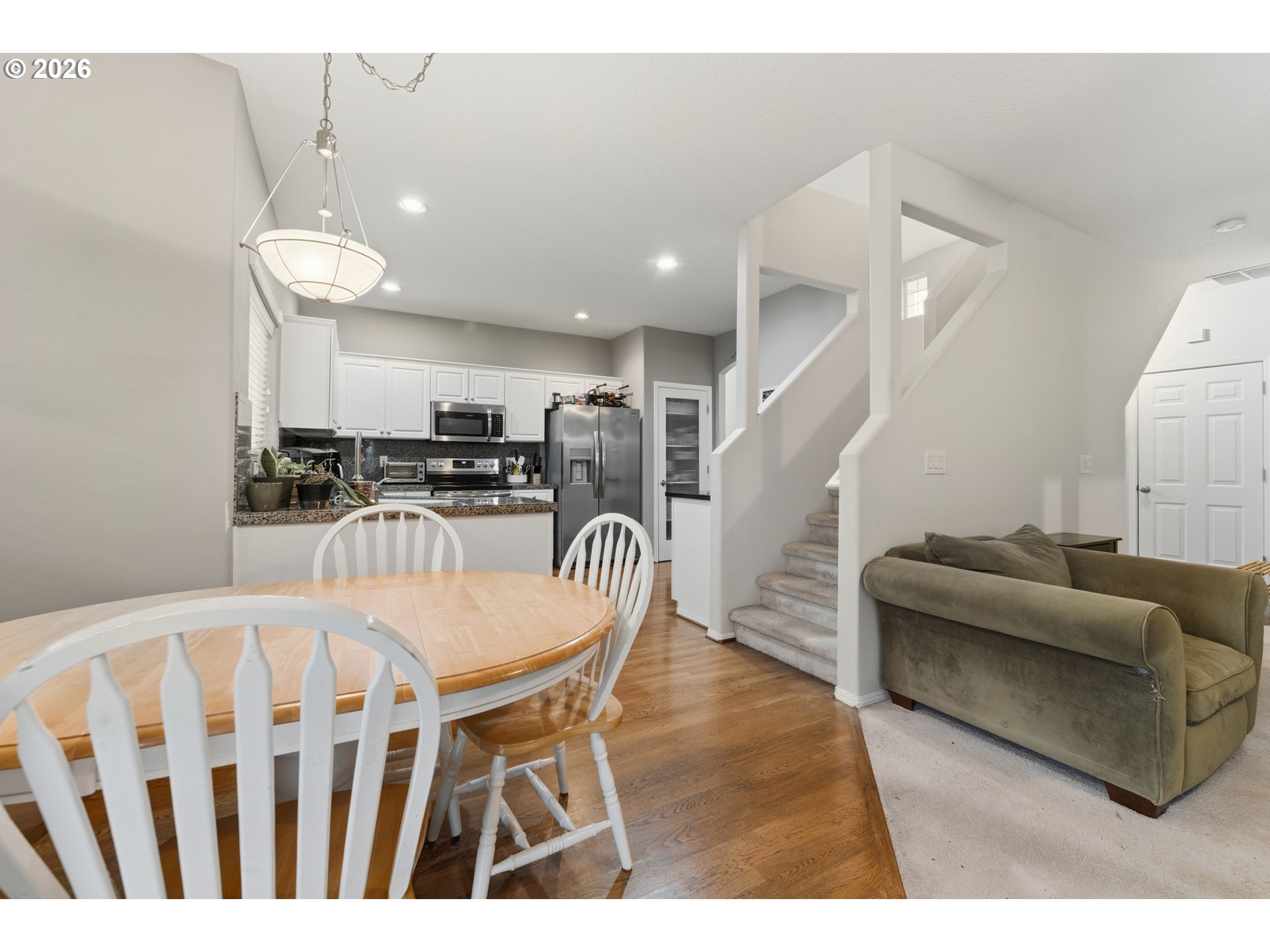 15852 Southeast Upman Way Damascus, OR 97089 - Photo 9 of 43 a dining room with furniture and wooden floor