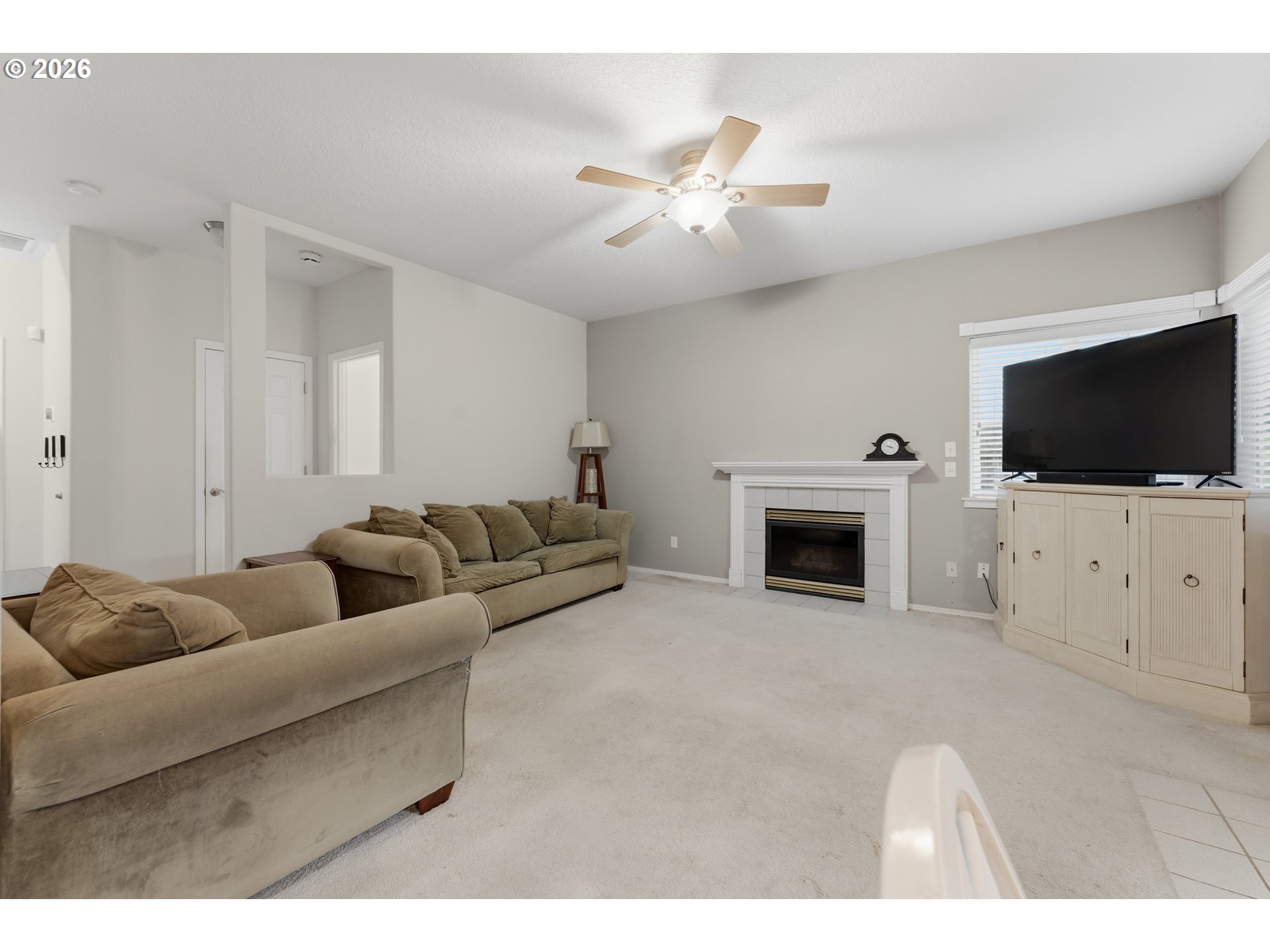 15852 Southeast Upman Way Damascus, OR 97089 - Photo 10 of 43 a living room with furniture and a flat screen tv