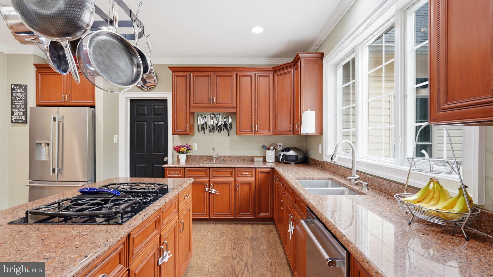 15613 Thoroughfare Road Gainesville, VA 20155 - Photo 14 of 63 a kitchen with stainless steel appliances granite countertop a stove a sink and a granite island