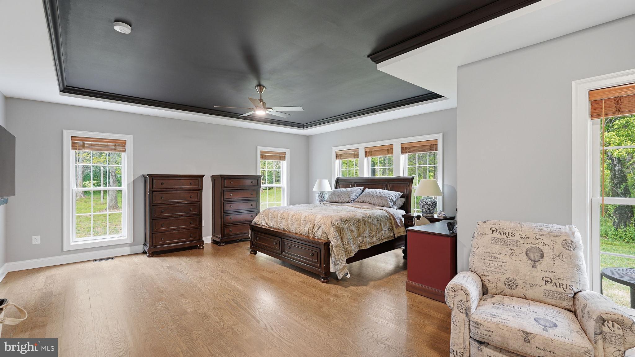 15613 Thoroughfare Road Gainesville, VA 20155 - Photo 24 of 63 a spacious bedroom with a bed and a couch