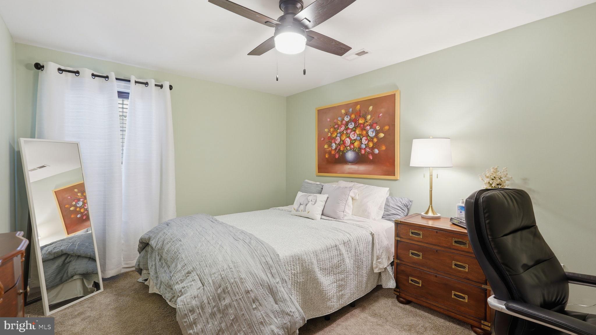 15613 Thoroughfare Road Gainesville, VA 20155 - Photo 49 of 63 a bedroom with a bed and a chandelier